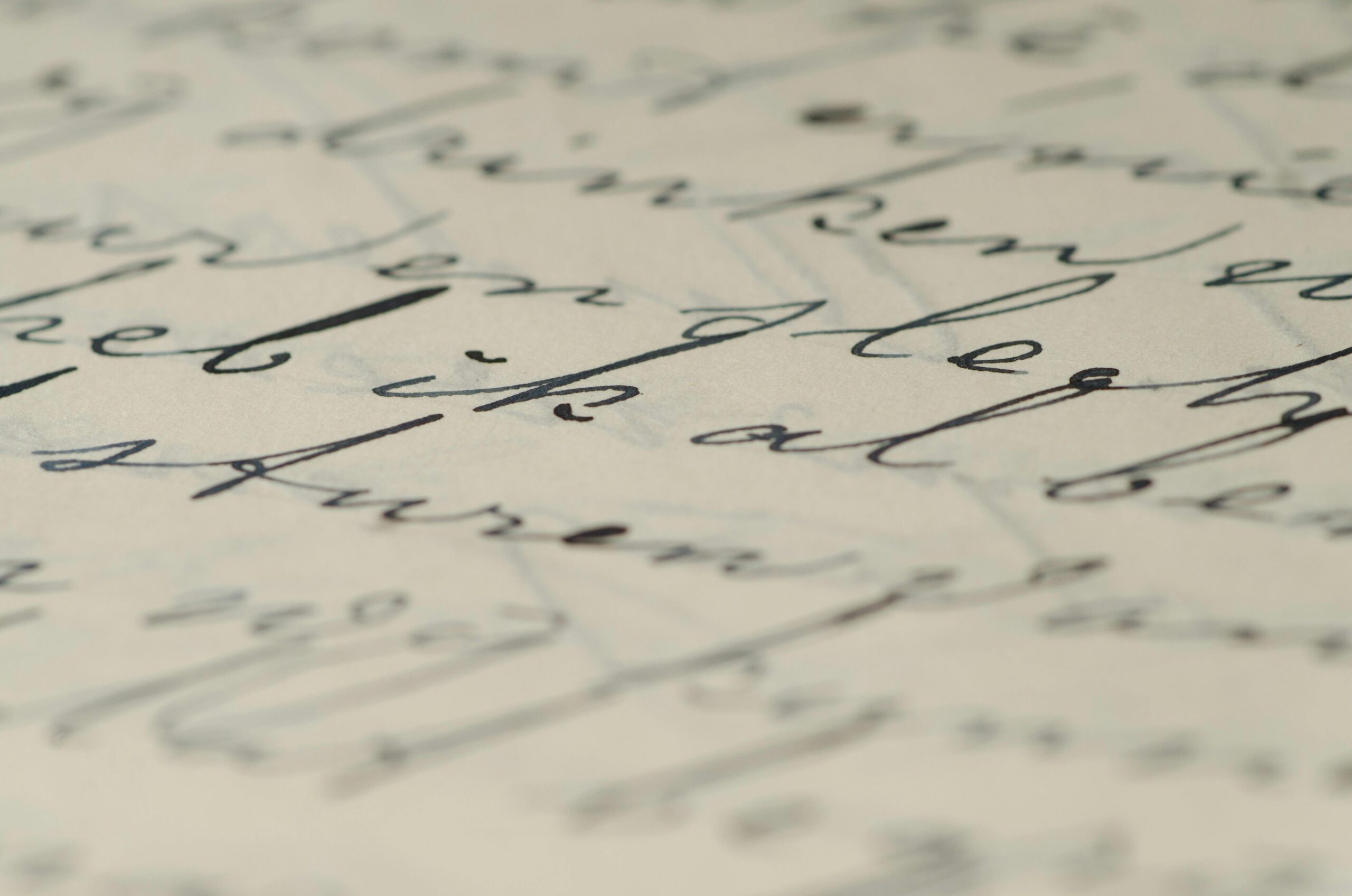 Close-up of elegant handwritten calligraphy on paper showcasing fine ink script.